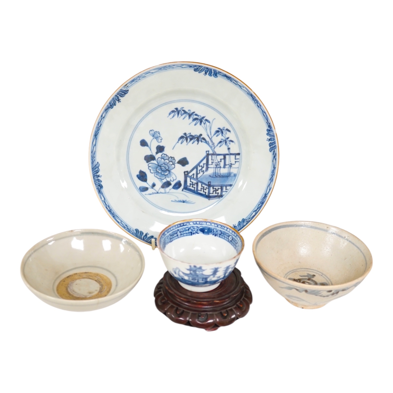 A Chinese blue and white plate, a tea bowl, two pottery bowls and a wooden stand (5). Condition - fair to good.